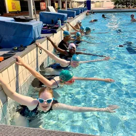 Swim squad training in lanes at Delta
